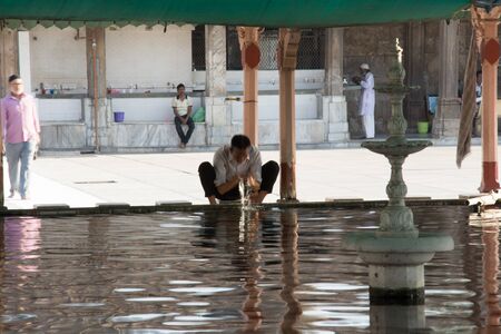 Ahmedabad / India / April 11, 2017: Indian man washing his self before praying at the mosque
