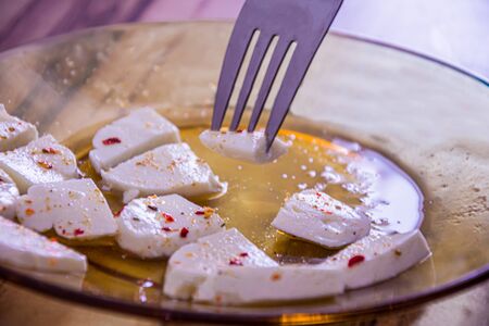 One piece of cheese with chilly spices among others prepared to be eatenの写真素材