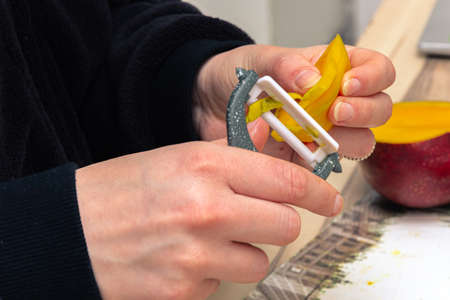 Close up of the mango peeled with a gray peeler