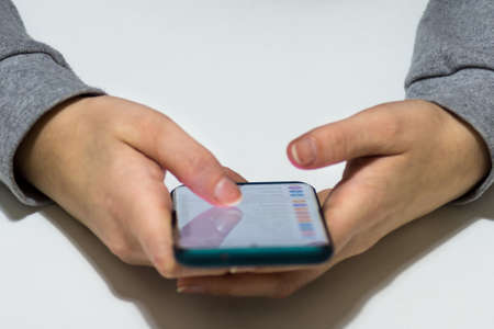 Woman's hands browsing on the new smartphone with case