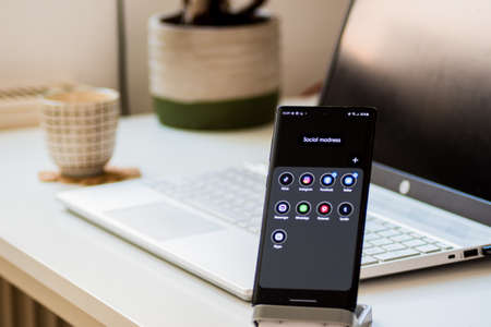Vienna / Austria / November 13, 2020: Black smartphone on phone stand with social media applications, Instagram, Facebook, and othersのeditorial素材