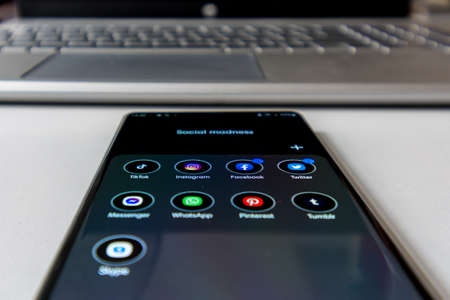 Vienna / Austria / November 13, 2020: Central perspective of black smartphone with android apps on...