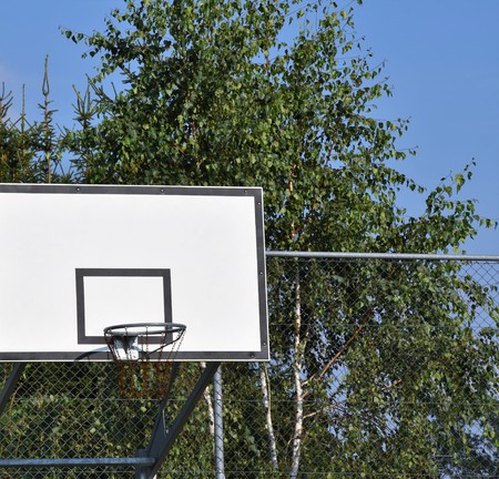 Photo of basketball hoop and blue sky in background