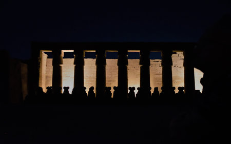 Silhouette of a group of people at the entrance to the Temple of Debod, Luxor, Egyptの写真素材