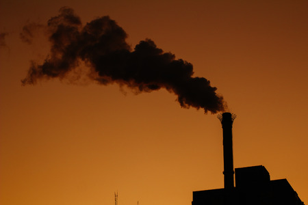 Chimney is smoking, under the twilightの写真素材