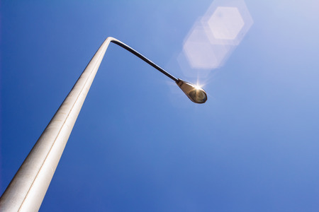 Street light is shining under the sunshineの写真素材