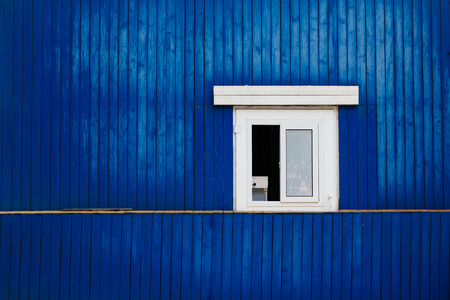 window on the blue wooden wallの写真素材