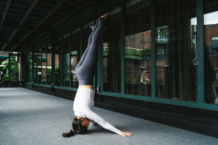Young woman practice yoga in the parkの写真素材