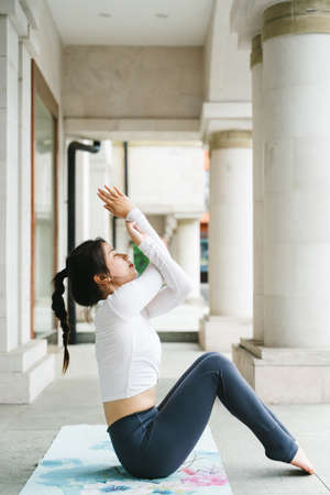 Young woman practice yoga in the parkの写真素材