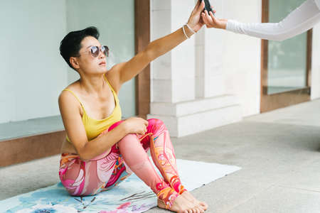 Young woman practice yoga in the parkの写真素材