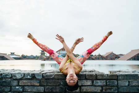 Young woman practice yoga in the parkの写真素材