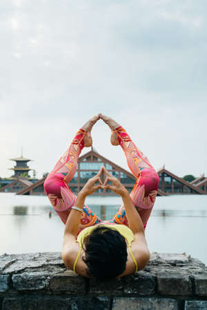 Young woman practice yoga in the parkの写真素材