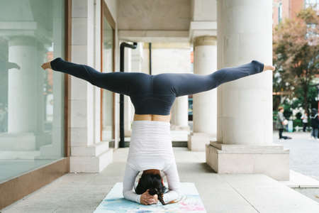 Young woman practice yoga in the parkの写真素材