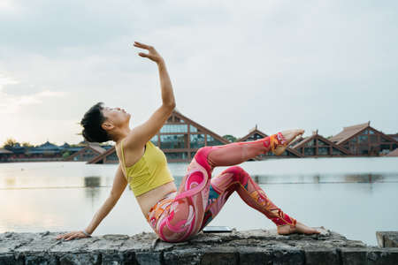 Young woman practice yoga in the parkの写真素材