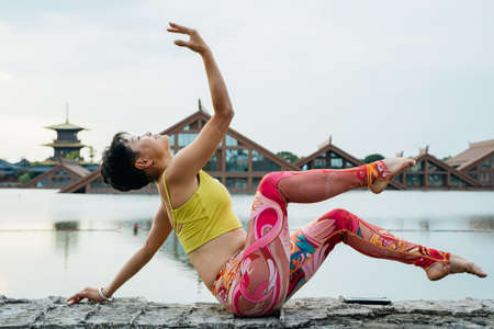 Young woman practice yoga in the parkの写真素材