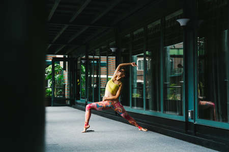 Young woman practice yoga in the parkの写真素材