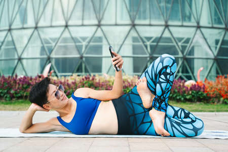 Young women practice yoga in the parkの写真素材