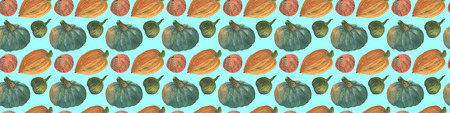 The orange and greenery pumpkins seamless watercolor pattern background with the natural paper texture for the creative design of the eco shop and bio store, organic food.の写真素材