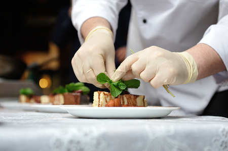 The confectioner decorates dessertの写真素材