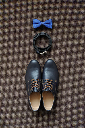 Men's accessories on the carpet, shoes, tie and belt.の写真素材