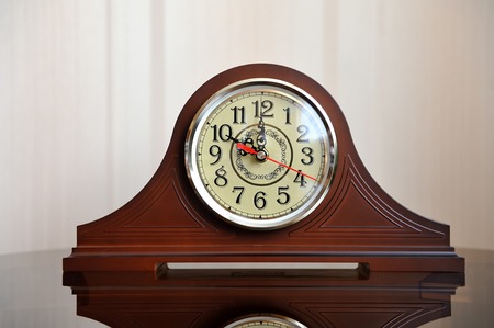 Beautiful clock in retro style on a glass table