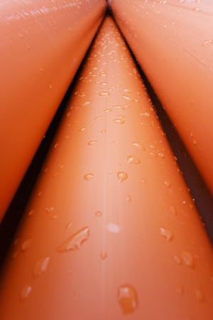 Large orange plastic pipes for sewerage system.