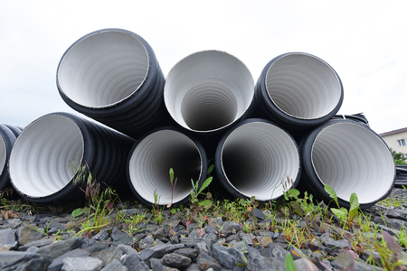 New black-and-white plastic pipes for sewerage system.