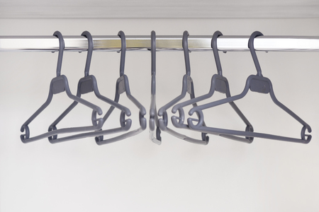 An empty wardrobe and clothes hangers in it. Hangers for clothes in an empty cupboard.の写真素材