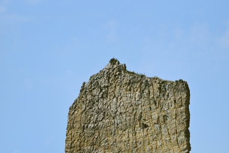 Beautiful and unusual rock on a blue sky background, flat and high. Her name "Sail" in Russian language "Parus". Located near the city of Gelendzhik in the village of Praskoveevka". Located near the city of Gelendzhik in the village of Praskoveevka.の写真素材