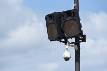 Lamp post on which installed music speakers and video surveillance camera.