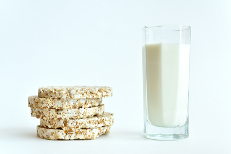 Glass of milk and crisp bread for breakfast on a white background.の写真素材
