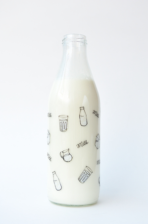 Beautiful and thematic bottle with milk on white background, close-up.の写真素材