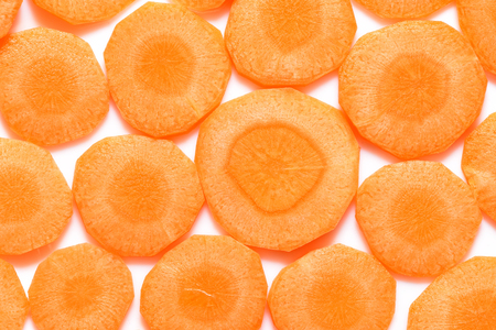 Fresh sliced carrot slices on a white background. Close-up.の写真素材