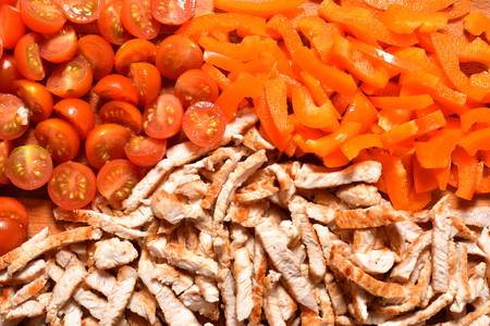 Fried and chopped chicken or turkey  meat and chopped sweet peppers. Ingredients.の写真素材