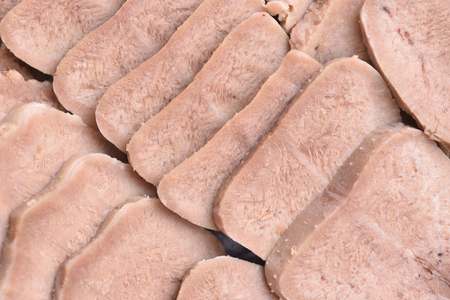 Meat delicacy sliced tongue. Boiled tongue close-up. Meat snack.の写真素材