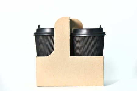 Disposable paper cups of black color in the container Paper cups for hot coffee. Coffee to go. Paper cup for coffee.の写真素材