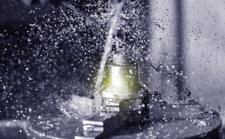 Spindle chuck and installed metal part in pocessing on high precision Cnc industrial lathe turning machine. CNC machine drills a hole in a metal part Close up.の写真素材