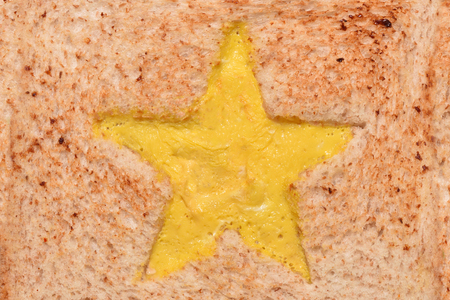 The texture of the surface of a fried sandwich with an omelette star.