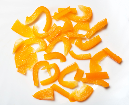 Slice of yellow sweet bell pepper on the white background, top view. Sweet yellow bell pepper slice partの写真素材