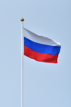 Bright flag of the Russian Federation against the sky.の写真素材