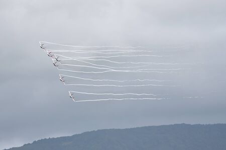 Gelendzhik, Russia - September 8, 2018: Russian aerobatic team on fighter planes on a background of rainy sky. Aerobatic team Strizhyのeditorial素材