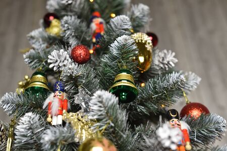 Decoration in the form of bells, balls and nutcrackers hanging on a Christmas treeの写真素材