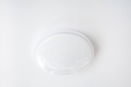 Ordinary round white chandelier on a white ceiling background,の写真素材