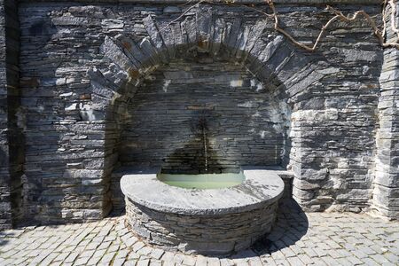 Beautiful Stone Spring with Drinking Water in Mainau, Europeの写真素材