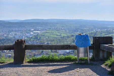 Metal trash bin on the background of the city with text spaceの写真素材
