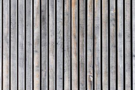 The texture of an aged wooden wall of planks without painting.の写真素材