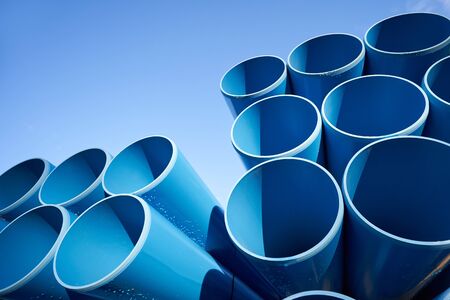 Large blue pipes for sewage against a blue sky with text spaceの写真素材