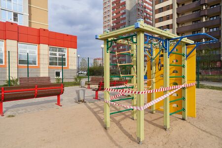 A closed playground for children with tape during the COVID-19 pandemic.