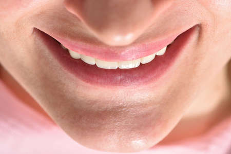 Female ceramic teeth and smile close-up. Beauty and body care conceptの写真素材