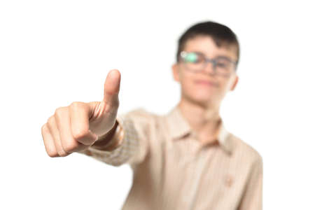 Teenager boy with glasses showing thumbs up gesture on white backgroundの写真素材